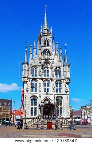 Gouda Netherlands - April 20 2016: old city hall of Gouda with unidentified people. It was built between 1448 and 1450 and is one of the oldest Gothic city halls in the Netherlands