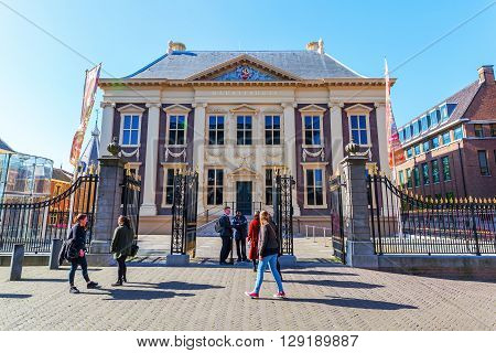 The Hague Netherlands - April 21 2016: Mauritshuis in The Hague with unidentified people. It is an art museum that houses the Royal Cabinet of Paintings with mostly Dutch Golden Age paintings