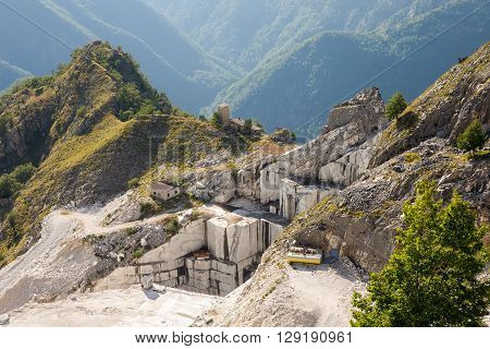 Marble Mine - Working marble mine in the Italian Alps near Carrara in Tuscany in Italy. Birds eye view. Carrara marble is widely recognized for its superior quality.
