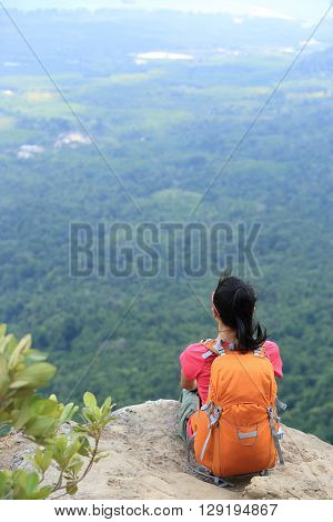 successful woman hiker enjoy the view on mountain top