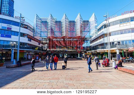 Almere Netherlands - April 20 2016: railway station of Almere with unidentified people. Almere is a fast growing planned city. With a population of about 200000 it is the 7th largest Dutch city