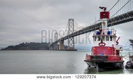 San Francisco, California - August 3, 2014: Firefighter boat by Bay Bridge, San Francisco, California