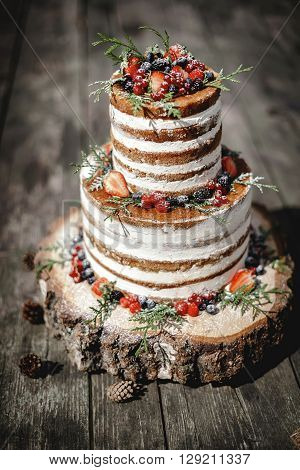 wedding cake in rustic style with berries