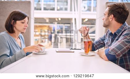 Caucasian male and female couple having relationship issues. They are not even able to make eye contact with one and other, as both of the put off initiating conversation.