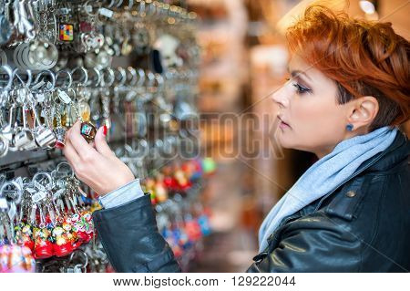 Young woman buying souvenirs in gift shop