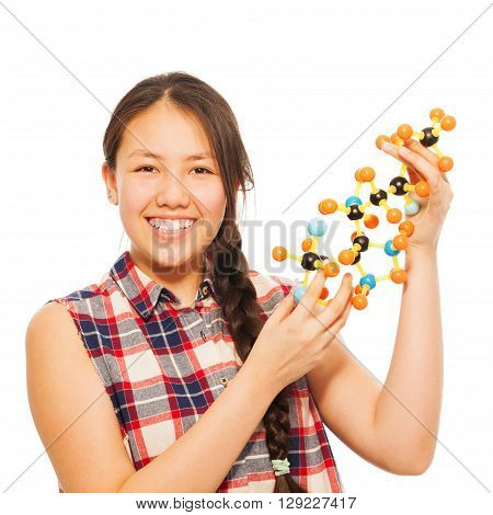 Smiling Asian teenage schoolgirl examining molecular structure, isolated on white background