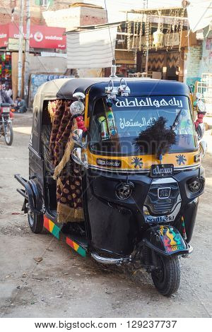 DARAW, EGYPT - FEBRUARY 6, 2016: Tuk-tuk vehicle parked on the street.