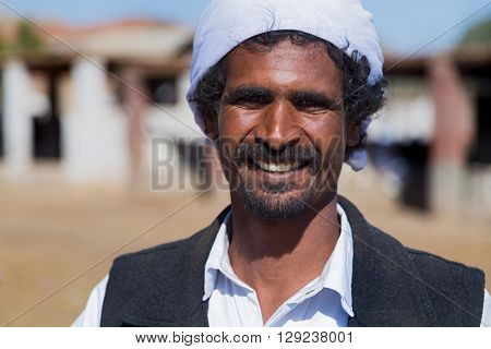 DARAW, EGYPT - FEBRUARY 6, 2016: Portrait of local camel salesman with turban.
