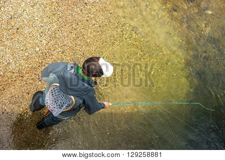 Fly Fisherman Fishing Trouts In  River