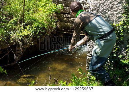 Fly Fisherman Fishing Trouts In  River