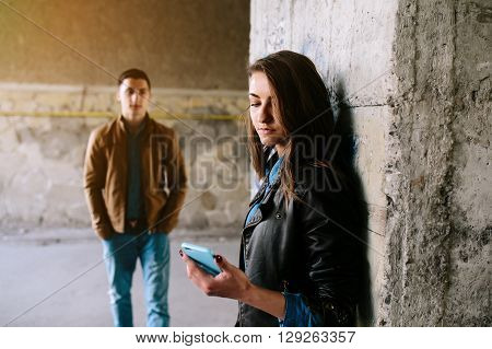 handsome guy and beautiful girl posing in a bystreet