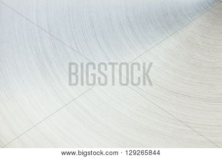 The polished silver surface. The semicircular line. The background.