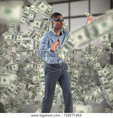 Blindfolded businessman with arms out against room with large window showing city