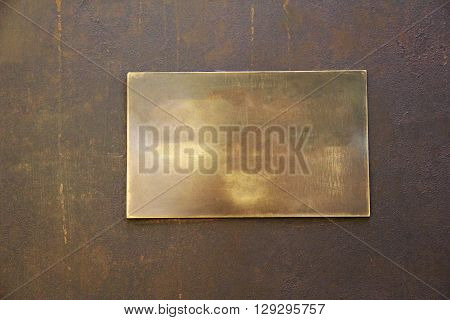 rectangular empty gloomy and with spots metal plate on a iron background