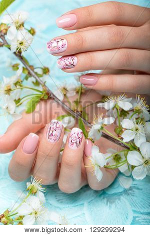 Spring manicure for the bride in gentle tones with flowers. Nail Design.