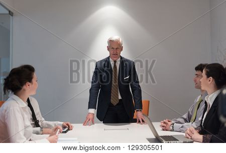 business people group brainstorming on meeting and businessman presenting ideas and projects oon laptop and tablet computer