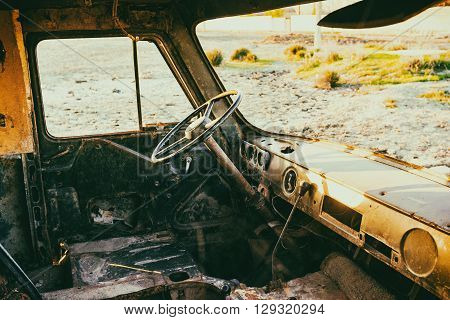 Abandoned rusty car. Retro style toned photo