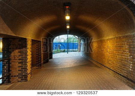London urban underground brick tunnel with lights next to Albion Channel