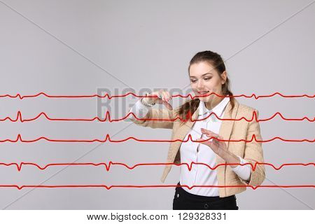 Doctor woman working with cardiogram lines