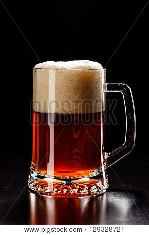 Beer Glass With Drops On Black. Fresh! Much Foam! Beer Bubbles Closeup. Draft. Overflow Beer Glass.