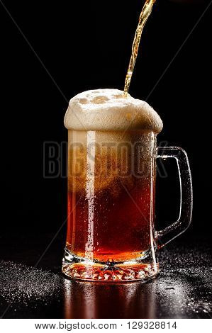 Process Filling Beer Glass With Drops On Black. Fresh! Much Foam! Beer Bubbles Closeup. Draft. Overf