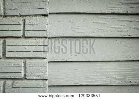 Patterned wood and brick on the wall of old wooden house Painted bright blue