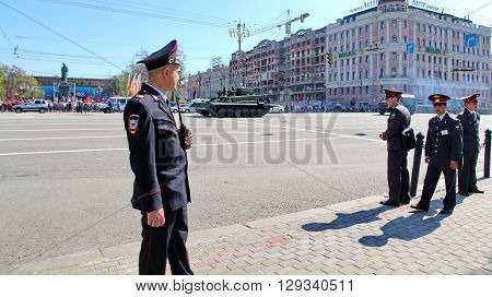 MOSCOW RUSSIAN - MAY 9 2013: Policemen in cordon wait for motorcade on TverskayaStreet on parade devoted to devoted to Victory Day. For editorial use only.