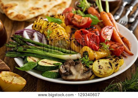 Grilled vegetables and chicken on wooden table overhead shot