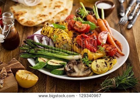 Grilled vegetables and chicken on wooden table overhead shot