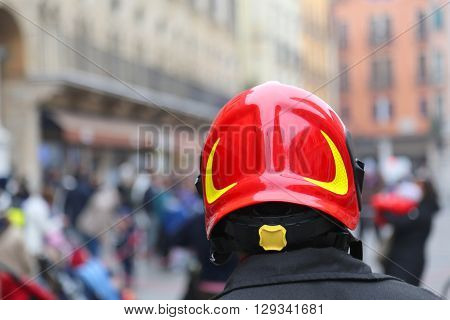 Watch fireman with red Hardhat controls the people of the city during the protest March
