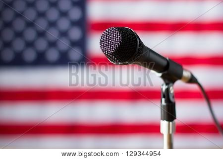 Microphone on US flag background. Banner and microphone with wire. Truth will soon be told. Broadcast for american citizens.
