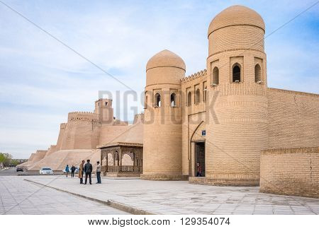 Khiva Uzbekistan - Aprilr 14 2014: People near the main gate of the Ichan Kala citadel