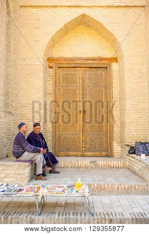 Buckara Uzbekistan - Aprilr 16 2014: Local vendors in the market on the side of the Kalon mosque