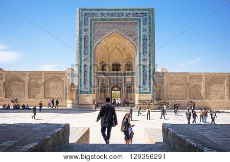 Buckara Uzbekistan - Aprilr 16 2014: Local people in front of the Kalon mosque