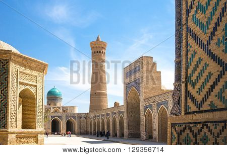 Buckara Uzbekistan - Aprilr 16 2014: Local people and tourists in the inside square of the Kalon mosque