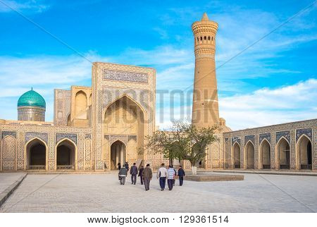 Buckara Uzbekistan - Aprilr 16 2014: Local people in the inside square of the Kalon mosque