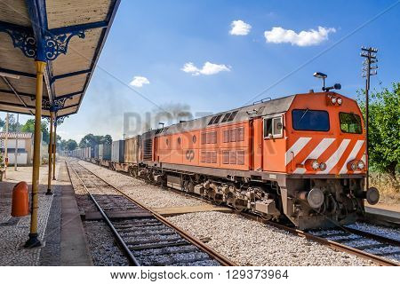 Crato, Portugal. July 2, 2015: Diesel locomotive, model 1960 - bombardier, with a freight train from Comboios de Portugal (Portuguese trains).