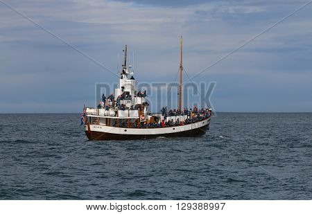 Husavik, Iceland - August 14, 2015: Tourists on a Boat at Whale Watching in Husavik.