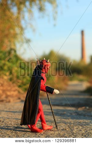 Doll of Devil with forks on the road