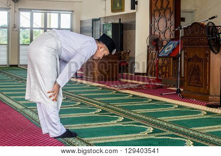 Labuan,Malaysia-March 19,2016:Young muslim performing prayers inside the mosque. The five prayers are Fajr, Zuhr, Asr, Maghrib and Isha.