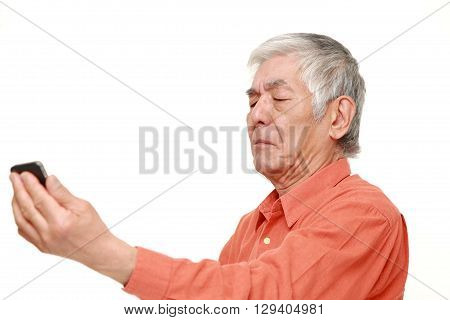 portrait of senior Japanese man with presbyopia