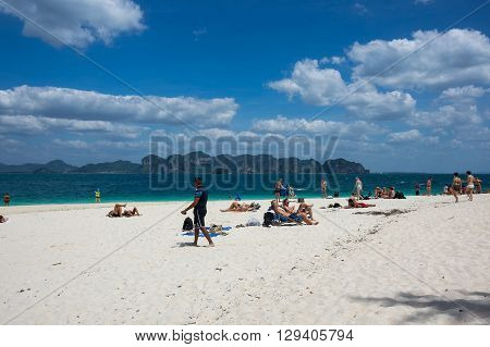 CRABI PROVINCE THAILAND - FEBRUARY 02 2015: Tourists relaxing on the beach of Andaman sea at Krabi province Thailand