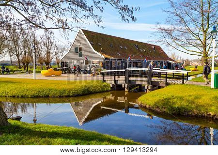 Zaanse schans, Netherlands - April 1, 2016: Wooden shoes, clogs or klompens museum, Zaanse Schans village, Holland, people around