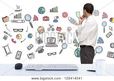 Thoughtful classy businessman looking away against desk