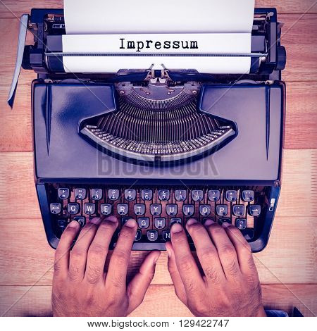 Impressum message against businessman typing on typewriter