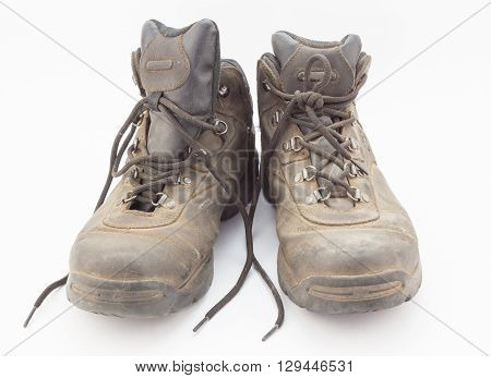 Dusty well used hiking boots isolated on white background