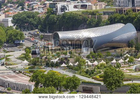 Tbilisi, Georgia - May 07, 2016: People In Apark In Front Of Concert Hall And The Official Residence