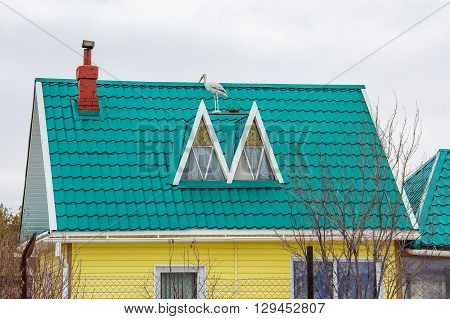 Russia Siberia Novosibirsk region Berdsk - April 17 2016: the country house with the roof covered with metal tile