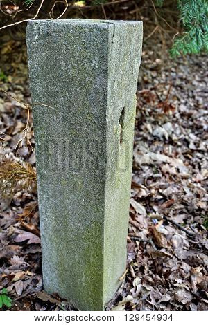 Aged stony milestone with a number one (1) craved into the stone as a symbol of start/beginning