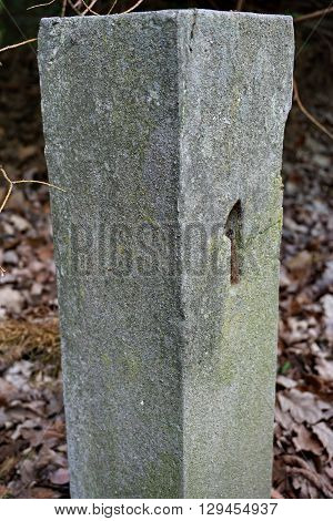 Aged stony milestone with a number one (1) craved into the stone as a symbol of start/beginning